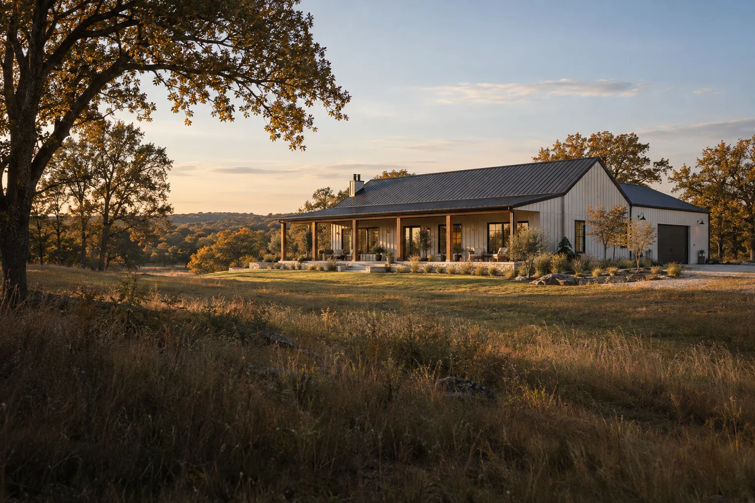 Architectural concept of a white barndominium and workshop set on wooded acreage